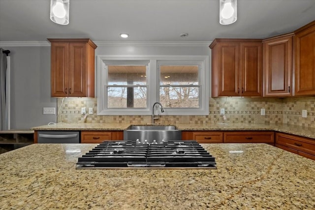 kitchen featuring sink, light stone counters, backsplash, pendant lighting, and appliances with stainless steel finishes