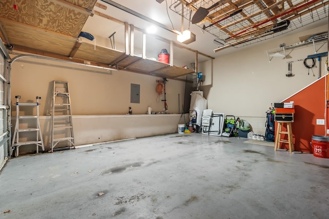 garage featuring electric panel and a garage door opener