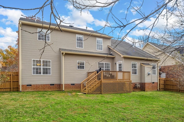 rear view of property with a lawn and a deck