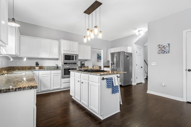 kitchen with a center island, white cabinetry, sink, and stainless steel appliances