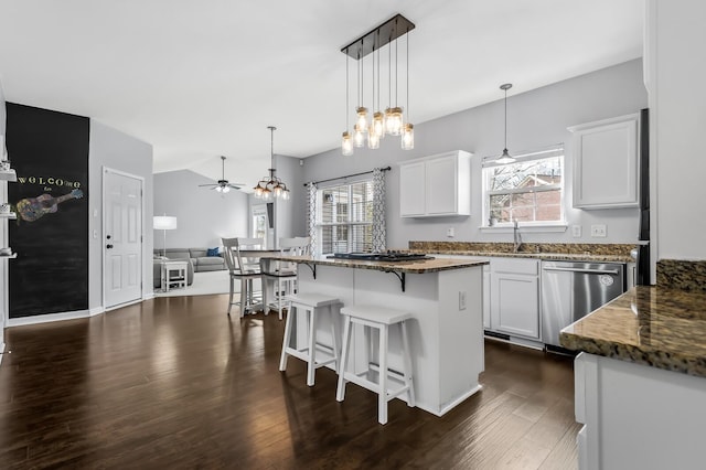 kitchen featuring white cabinetry, dishwasher, dark stone counters, and dark hardwood / wood-style floors