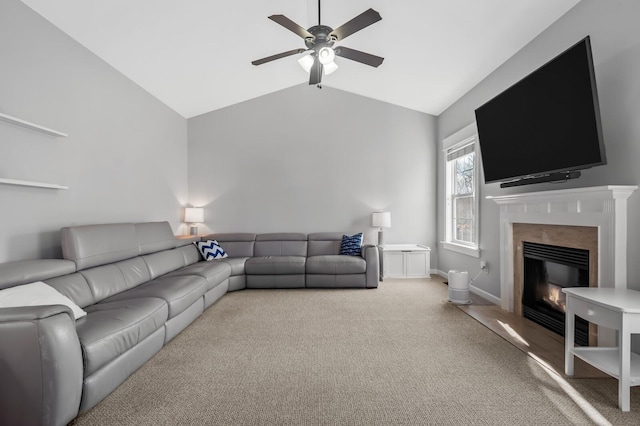 carpeted living room with ceiling fan and lofted ceiling