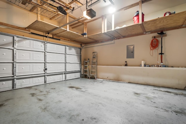 garage with a garage door opener and electric panel