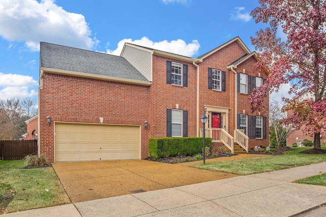 view of front of house with a garage and a front yard