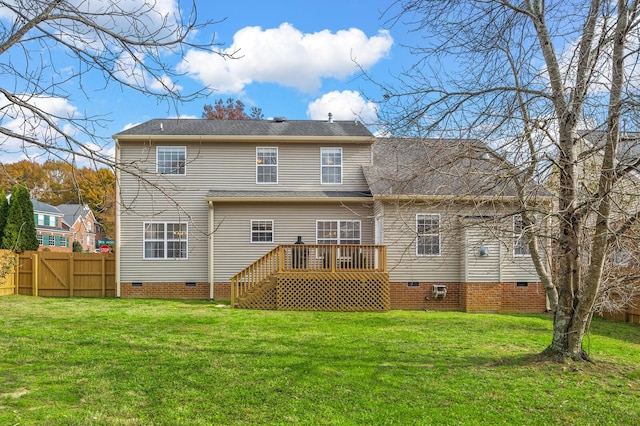 rear view of property with a wooden deck and a yard