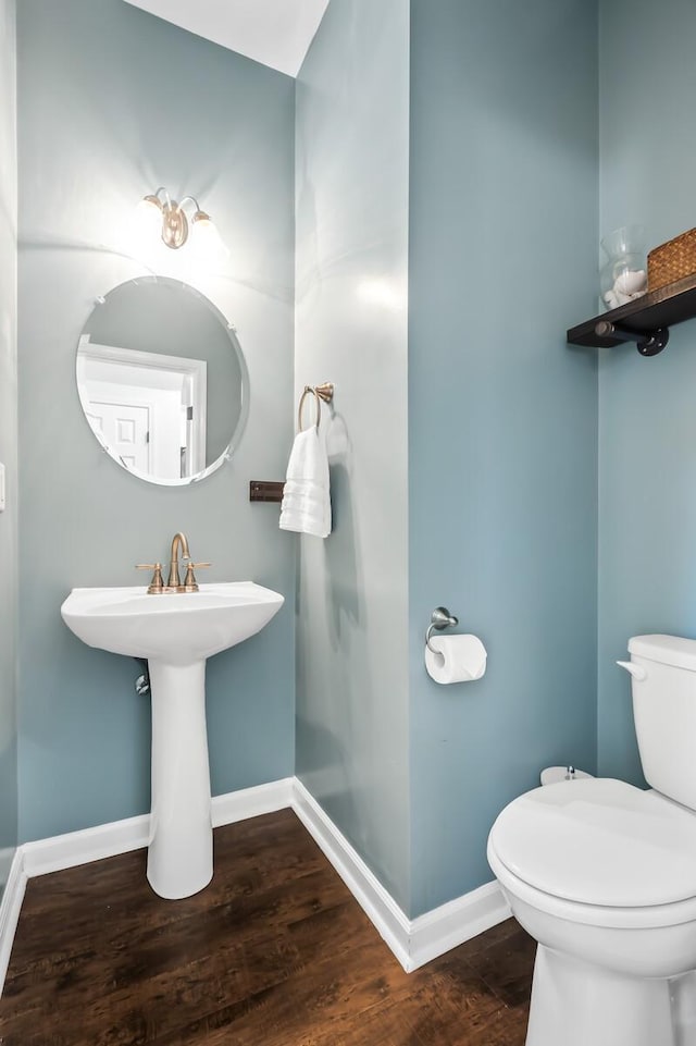 bathroom with hardwood / wood-style floors and toilet