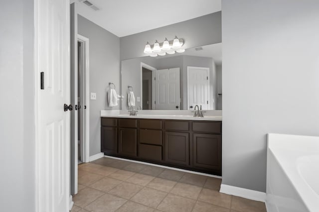 bathroom featuring tile patterned floors, a tub to relax in, and vanity