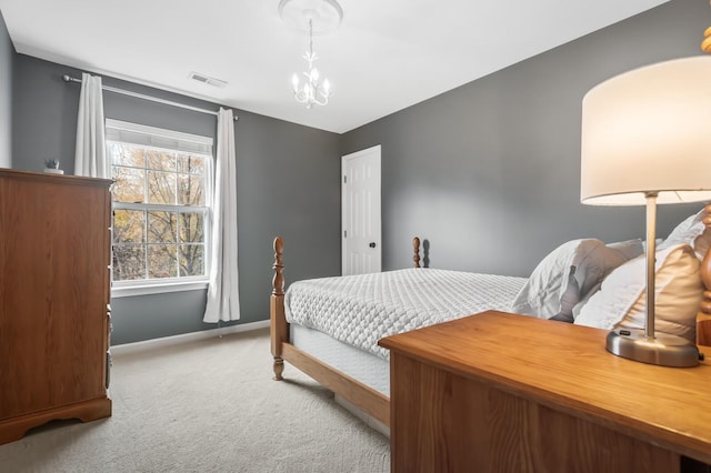 bedroom with light carpet and an inviting chandelier