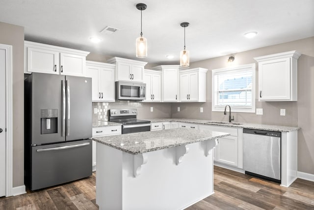 kitchen with sink, white cabinets, and appliances with stainless steel finishes