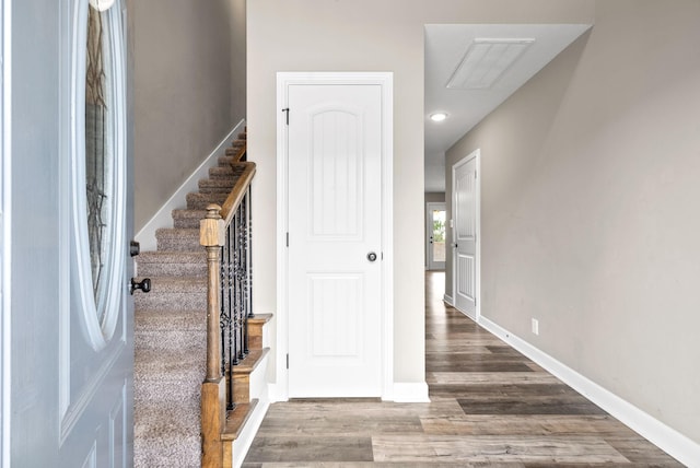 stairs with hardwood / wood-style floors