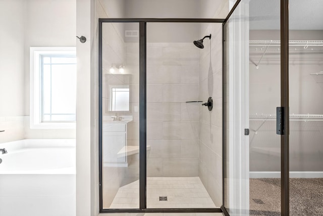 bathroom featuring separate shower and tub and a textured ceiling