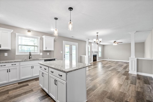 kitchen with sink, white cabinets, and plenty of natural light