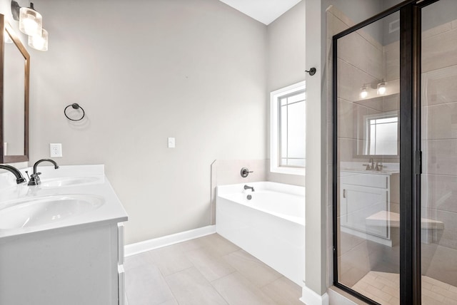 bathroom with vanity, tile patterned flooring, and plus walk in shower