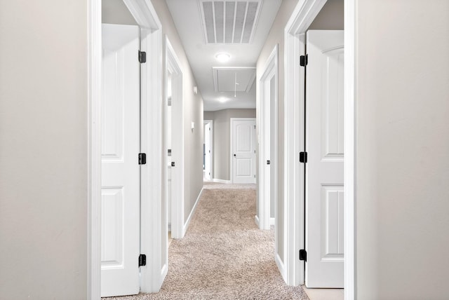 hall featuring light colored carpet