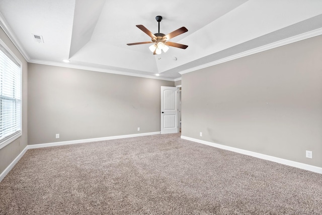 spare room featuring a tray ceiling, ceiling fan, carpet flooring, and ornamental molding