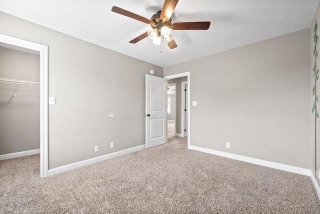 unfurnished bedroom with carpet, ceiling fan, and a closet