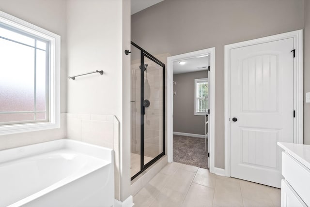 bathroom featuring tile patterned flooring, a healthy amount of sunlight, and plus walk in shower