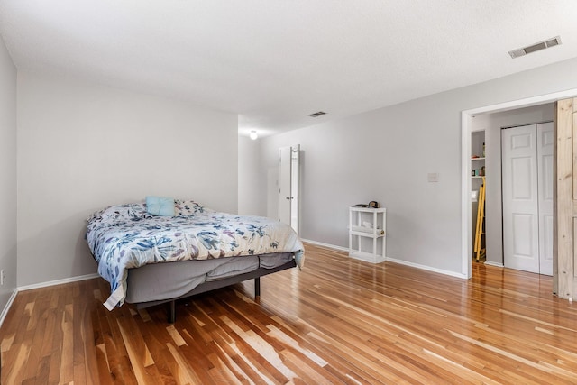 bedroom featuring a textured ceiling and hardwood / wood-style flooring