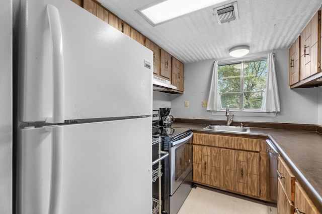 kitchen featuring sink, white fridge, stainless steel dishwasher, and electric range oven