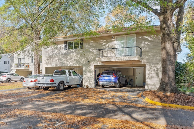 view of front of house with a garage and a balcony