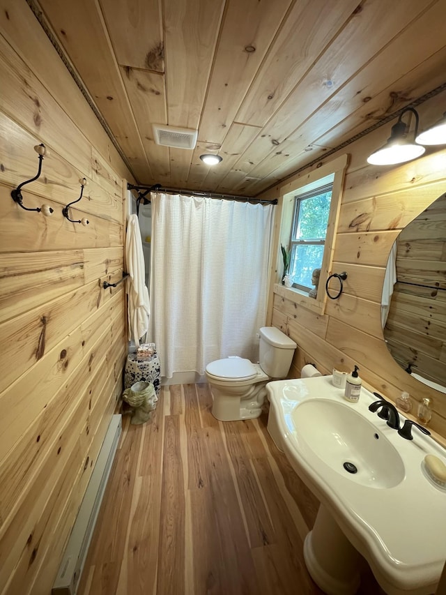 bathroom featuring wooden ceiling, a shower with curtain, wood walls, wood-type flooring, and toilet