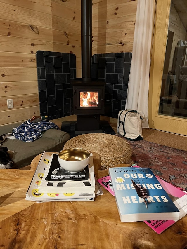 interior space featuring a wood stove and wooden walls