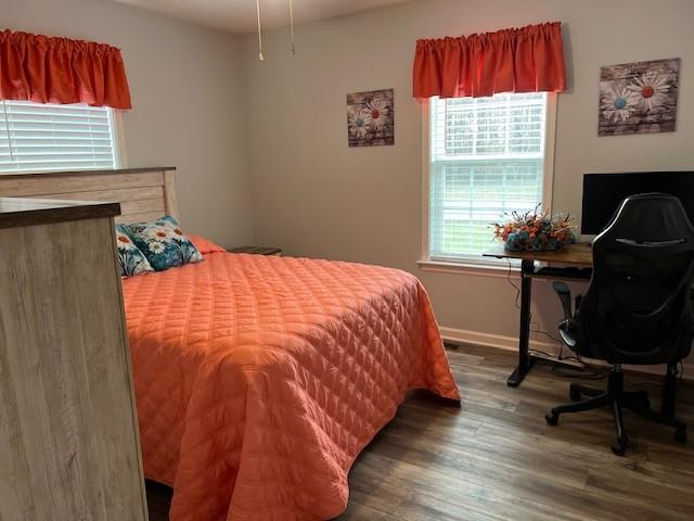 bedroom featuring dark hardwood / wood-style flooring