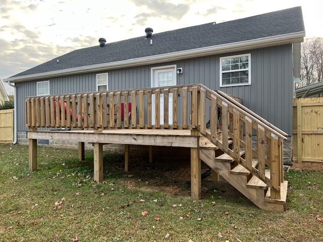 back of house with a yard and a deck