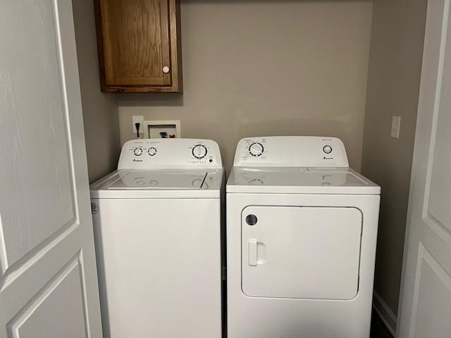 laundry room featuring cabinets and washing machine and clothes dryer