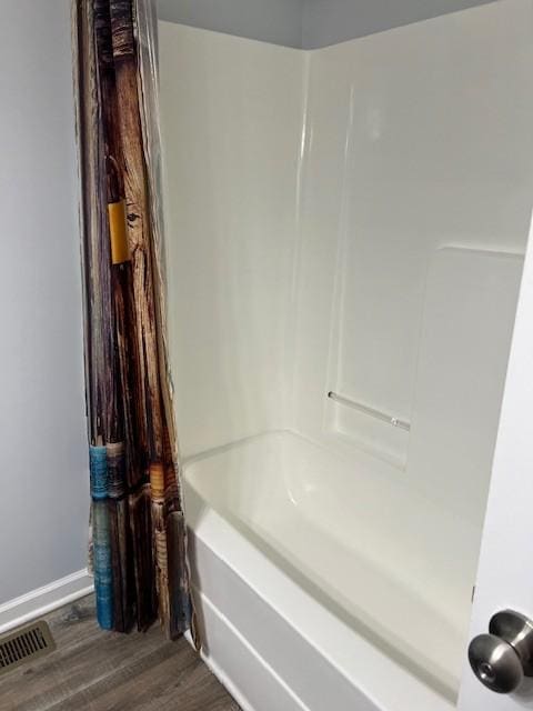 bathroom featuring shower / tub combo with curtain and wood-type flooring