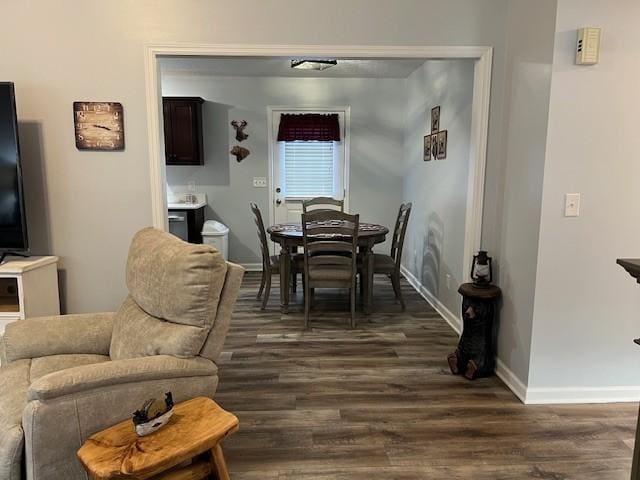 dining area featuring dark wood-type flooring