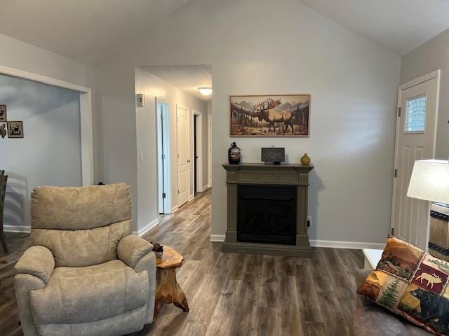 sitting room featuring dark hardwood / wood-style flooring and vaulted ceiling