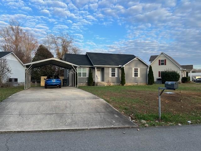 single story home featuring a front yard and a carport