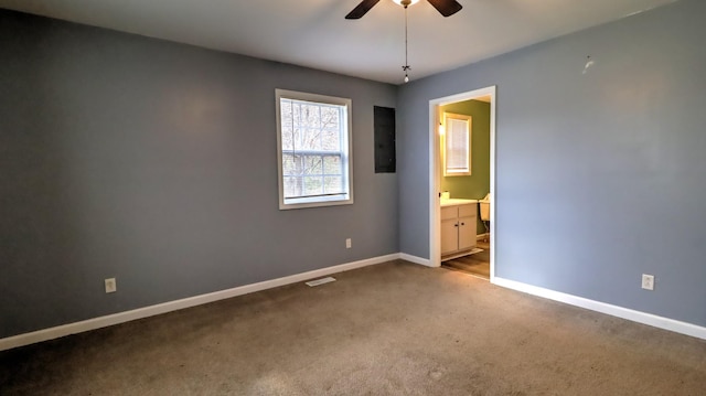 unfurnished bedroom featuring carpet flooring, ceiling fan, and ensuite bathroom