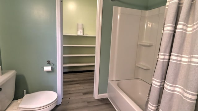 bathroom featuring hardwood / wood-style floors, toilet, and shower / bath combination with curtain