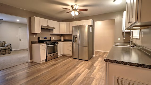 kitchen with white cabinets, sink, light hardwood / wood-style flooring, ceiling fan, and stainless steel appliances