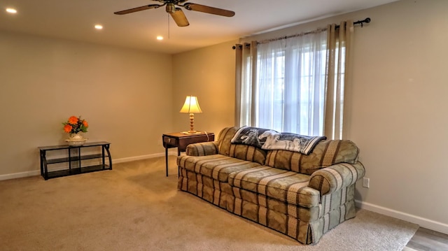 living room with carpet flooring and ceiling fan