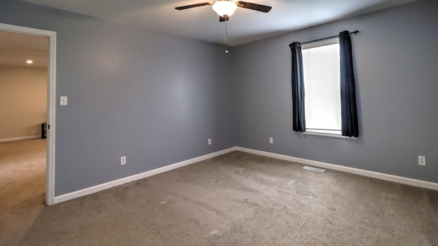 spare room with carpet floors and ceiling fan