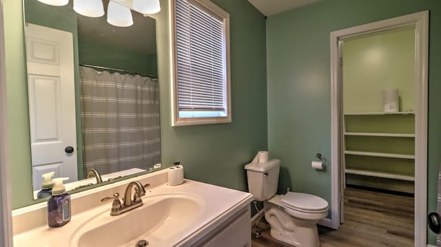 bathroom featuring hardwood / wood-style flooring, vanity, and toilet