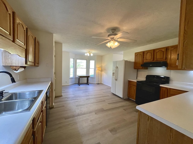 kitchen with ceiling fan, a textured ceiling, black appliances, light hardwood / wood-style flooring, and sink