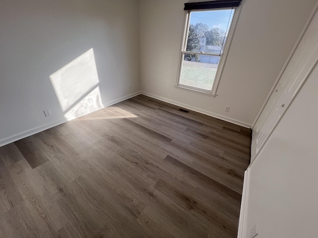 spare room featuring dark hardwood / wood-style floors