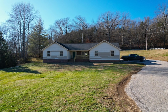 view of front of home with covered porch and a front lawn