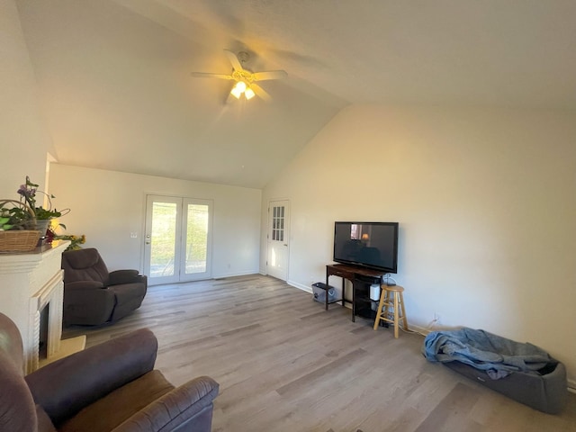 living room featuring vaulted ceiling, ceiling fan, and light hardwood / wood-style floors