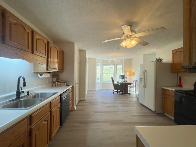 kitchen featuring ceiling fan with notable chandelier, a textured ceiling, black appliances, light hardwood / wood-style floors, and sink