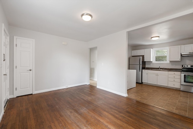 kitchen featuring appliances with stainless steel finishes, dark hardwood / wood-style flooring, ventilation hood, and white cabinetry