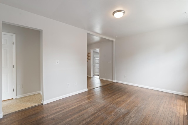 spare room with dark hardwood / wood-style flooring