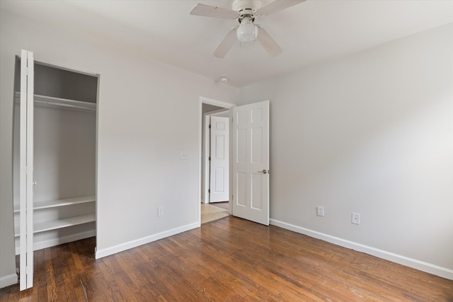 unfurnished bedroom featuring a closet, ceiling fan, and dark wood-type flooring