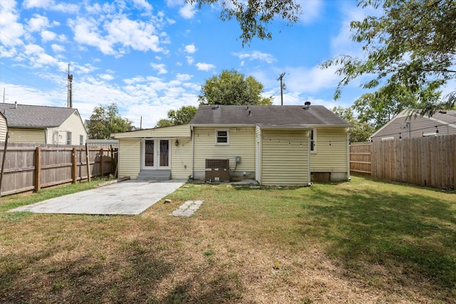 back of house with a lawn, a patio area, and central air condition unit