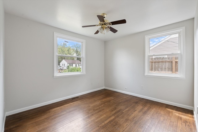 unfurnished room with ceiling fan and dark hardwood / wood-style flooring