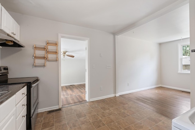 kitchen featuring white cabinetry, light hardwood / wood-style flooring, ceiling fan, and stainless steel range with electric stovetop